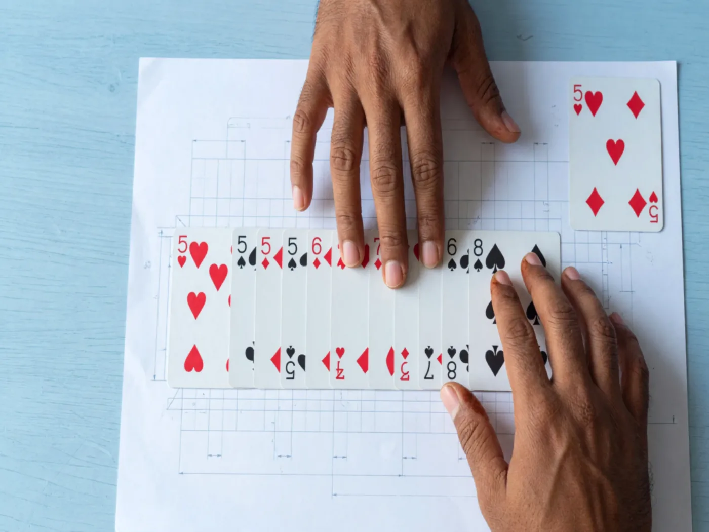Hands squaring a sequence beside a smaller completed set